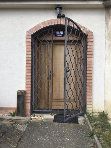 a door with a gate in front of a building at Sklep u Dušana in Vracov