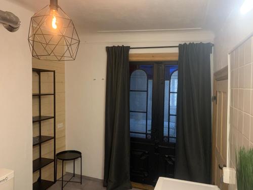 a living room with a window and a pendant light at Marktplatz Memmingen in Memmingen