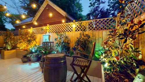 a patio with a barrel and chairs and a fence at Historic 2BR 1BA with King bed-Fast Wi-Fi 75 OLED TV in Wilmington