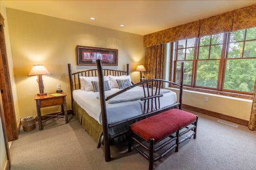 a bedroom with a canopy bed and a window at Snow King Resort in Jackson