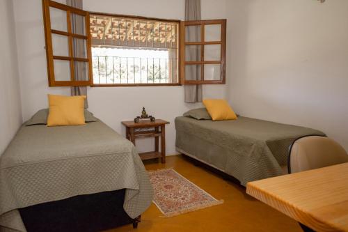 Ένα ή περισσότερα κρεβάτια σε δωμάτιο στο Casa em Bueno Brandão(MG) com Cachoeira Particular