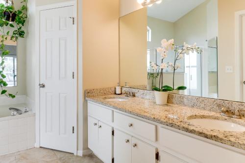 a bathroom with two sinks and a large mirror at Pet-Friendly Valrico Vacation Home with Lanai! in Valrico