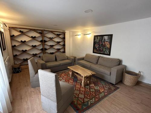 a living room with two couches and a table at Karse in Ambrolauri