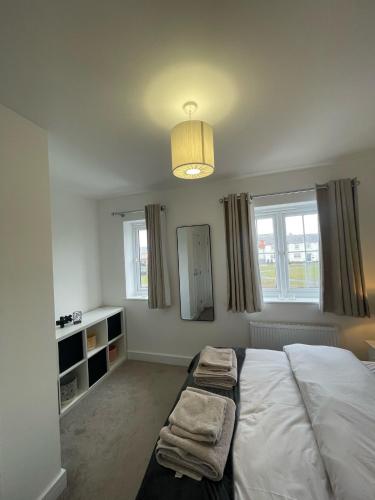 a bedroom with a large bed and a mirror at The Rita House in Doncaster