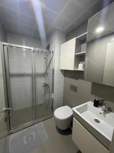 a bathroom with a shower and a toilet and a sink at Luxury Holiday - Spa, Olympic Pool, Fitness, Sauna No88 in Antalya