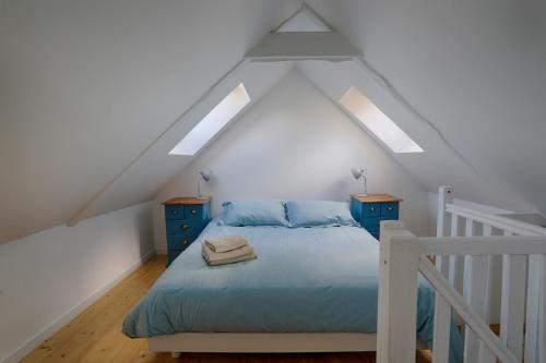 a bedroom with a bed and two night stands at FORET TOTEM - Hébergements nature et bien-être en pleine forêt in Persquen