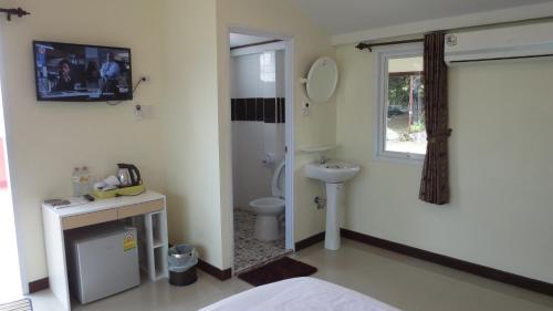 a bathroom with a toilet and a sink at Lomtalay Resort Trat in Ban Bang Pit Lang