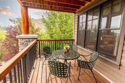 a patio with a table and chairs on a deck at Snow King Resort in Jackson