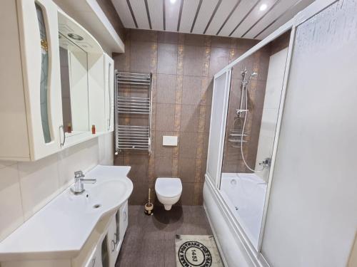 een badkamer met een toilet, een wastafel en een douche bij Best Apartments with Central View in Chişinău