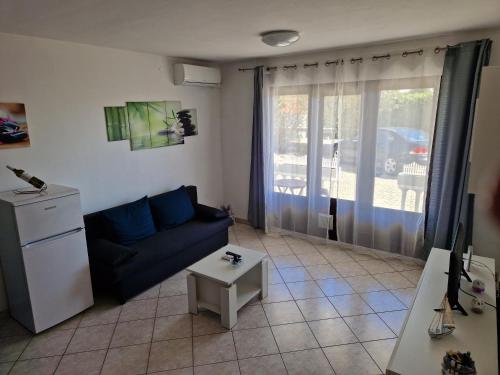 a living room with a couch and a table at Apartman"Petra" in Krk