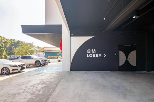 a garage with cars parked in a parking lot at Bagan Suite in Butterworth