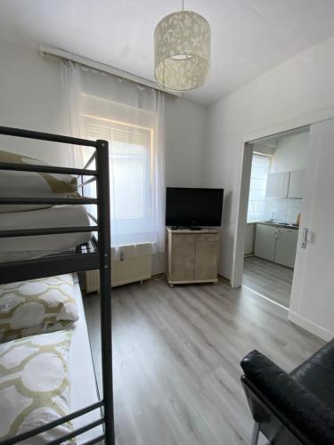 a living room with a bunk bed and a television at Moderne Monteurwohnung in Mönchengladbach Rheydt in Mönchengladbach
