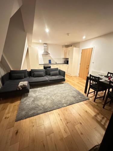 a living room with a couch and a dining room at Clarendon Flat in Watford