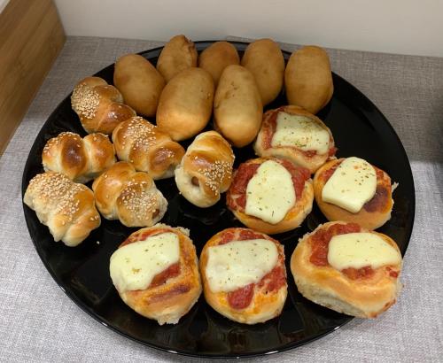 a plate of buns and other pastries on a table at B&B D'Amari Affittacamere in Palermo