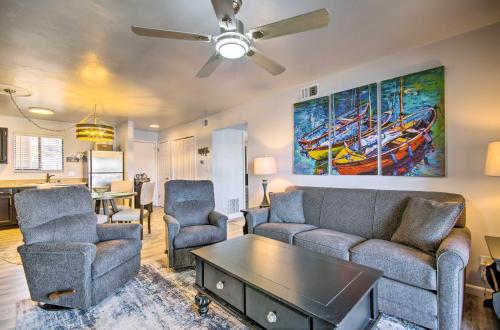 a living room with a couch and chairs and a painting of boats at Osage Beach Resort Condo with Community Pool! in Osage Beach