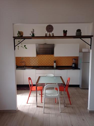 a kitchen with a table and two chairs and a table and a table at Casa Medea in Piombino