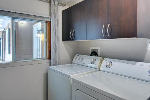 lavadero con lavadora y secadora y ventana en Sheldon Enchanting on Lake Cottage with Jacuzzi en Rivière-Rouge
