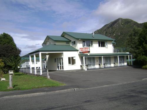 a large white building with a sign on it at Mataki Motel in Murchison