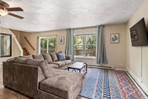 a living room with a couch and a table at Hot Tub! LRG Home! Sleeps 16!Near Ithaca! Dogs OK in Lansing