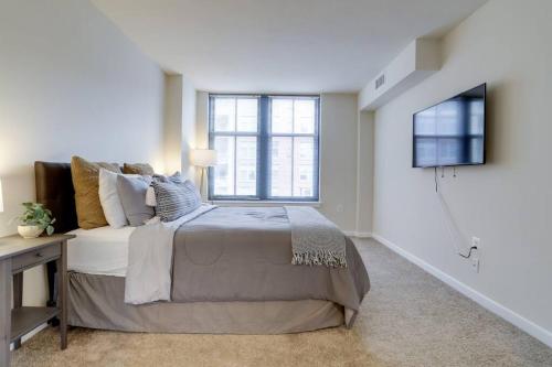 a bedroom with a large bed and a window at Fantastic 2 BR Condo At Pentagon City in Arlington