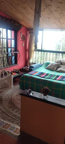 a bedroom with a bed and a table in it at El Pedregal Sopó in Sopó