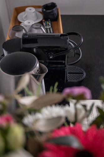 a table with a camera and plates and flowers at Auberge Sainte Marguerite in La Garde