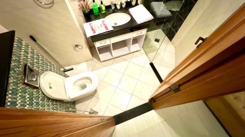 an overhead view of a bathroom with a toilet and sink at Centaurus Two Bedroom Apartment in Islamabad