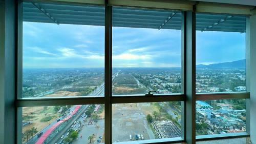 a view of a city from an office window at Centaurus Two Bedroom Apartment in Islamabad