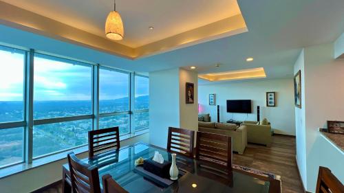 a living room with a glass table and chairs at Centaurus Apartment in Islamabad