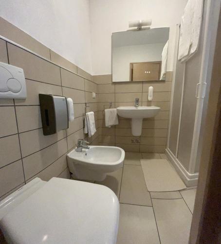 a bathroom with a toilet and a sink at Bed & Breakfast La Rondinella in Cerasolo