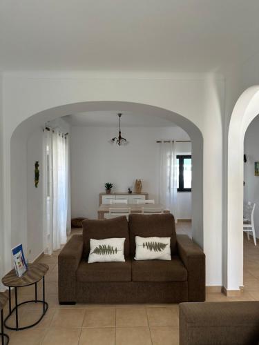 a living room with a couch and a table at Vila Mar Central in Albufeira