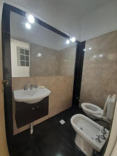 a bathroom with a sink and a toilet at Casa con piscina y parrillero in San Juan
