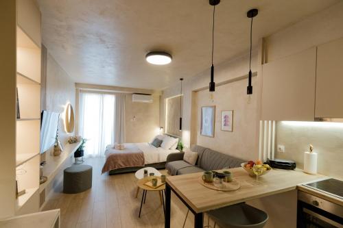 Apo-Zachari elegant apartment في لاريسا: مطبخ وغرفة معيشة مع سرير في غرفة