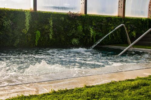 a pool of water with a water hose at Well Hotel & Spa in Maceira