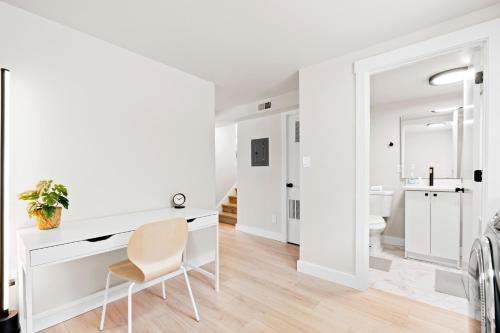 a white room with a desk and a chair at Modern Home near Salt Lake's Attractions in Salt Lake City
