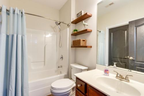 a bathroom with a sink and a toilet and a shower at Lakefront Condo with Pool Access in Osage Beach! in Osage Beach