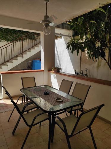 a table and chairs on a patio with a staircase at Antigone Holiday House in Mondello