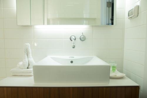 a bathroom with a white sink and a mirror at Prima Vera in Jerusalem