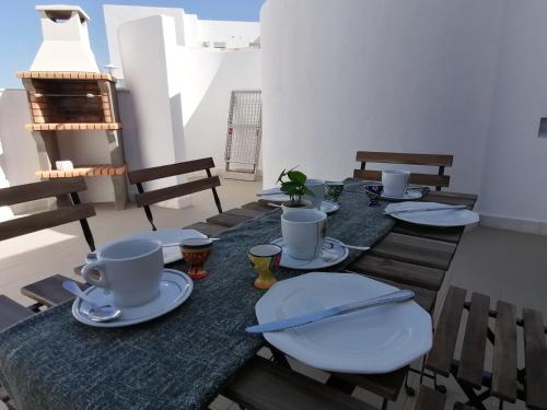 a table with plates and cups on top of it at Apartamento Viento Del Sur in Las Negras