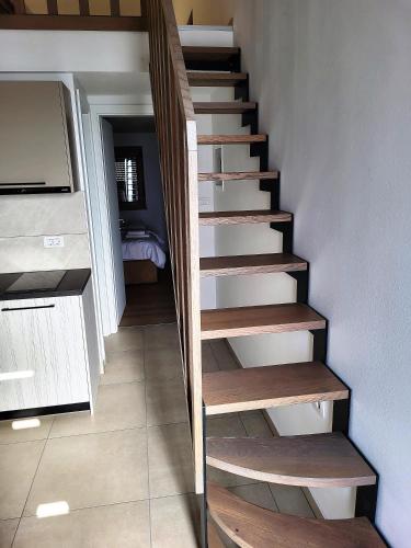 a staircase with wooden steps in a room at Prenočišča Iris in Sežana