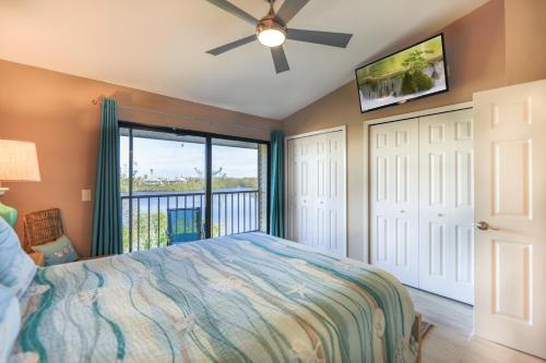 a bedroom with a bed and a large window at Lake Palms 3 in Sanibel