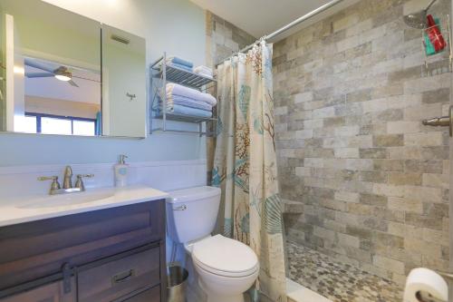 a bathroom with a toilet and a sink and a shower at Lake Palms 3 in Sanibel