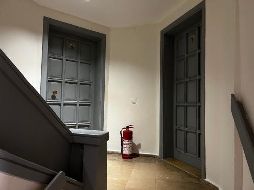 a fire extinguisher is sitting next to two doors at Andy's Apart Hotel in Marmaris