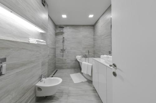 a bathroom with a sink and a tub and a toilet at K129 Living Apartment in Vilnius Center in Vilnius