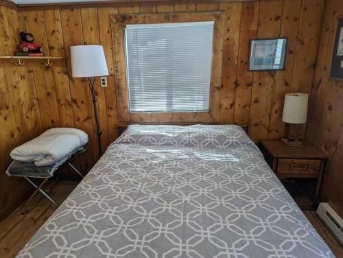 a bedroom with a bed in a wooden room at Stay Twin Lakes Cabin 4 in Twin Lakes