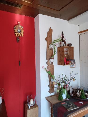 a room with red walls and a table with flowers at Hotel Tell in Seelisberg