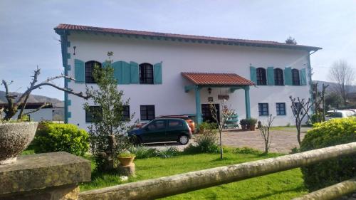 a house with a car parked in front of it at Apartamentos Florinda in Ucieda de Abajo