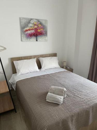 a bedroom with a bed with a towel on it at Enastron Cozy & Quiet Apartment in Heraklio
