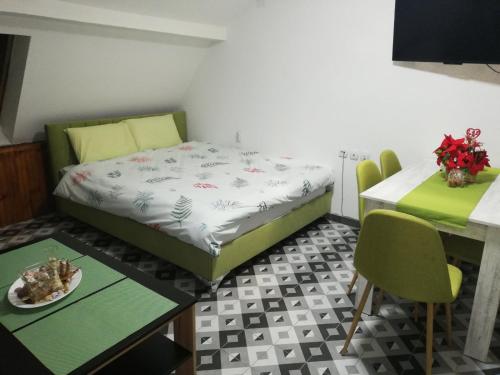 a room with a bed and a table with a plate of food at TOP 3 Apartments in Strumica