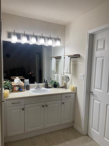 a bathroom with a sink and a mirror at Exclusive Private Room in the Shared Apartment by the Ocean in Los Angeles